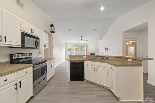 kitchen featuring white cabinetry, sink, an island with sink, and black appliances