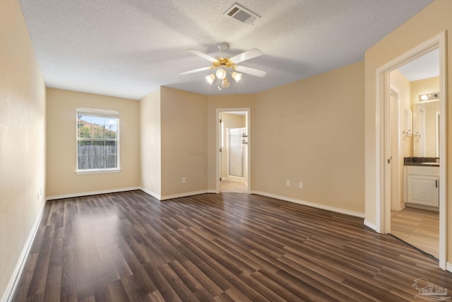 unfurnished room featuring ceiling fan, dark hardwood / wood-style flooring, and a textured ceiling