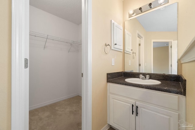 bathroom featuring vanity and a textured ceiling