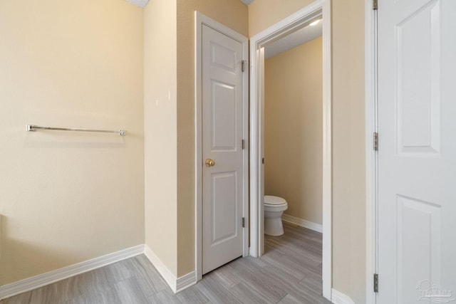 bathroom with wood-type flooring and toilet