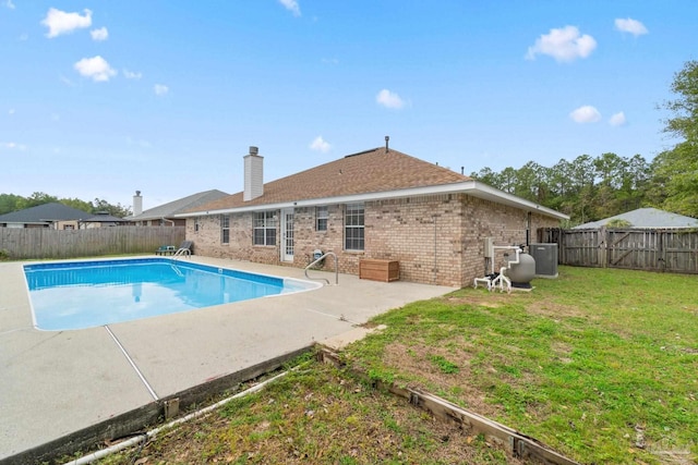 view of pool with a yard and a patio area