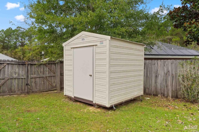 view of outbuilding with a yard