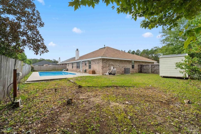 exterior space featuring a fenced in pool and a shed