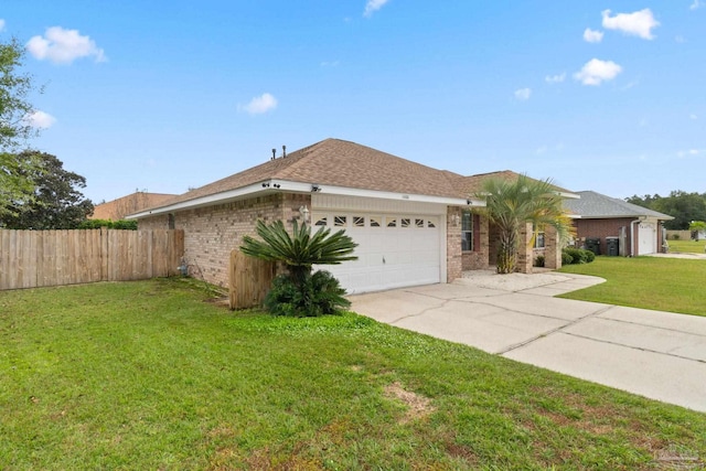 single story home featuring a garage and a front lawn