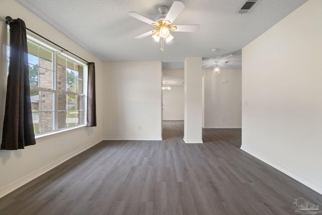 spare room featuring ceiling fan, dark wood-type flooring, and a textured ceiling