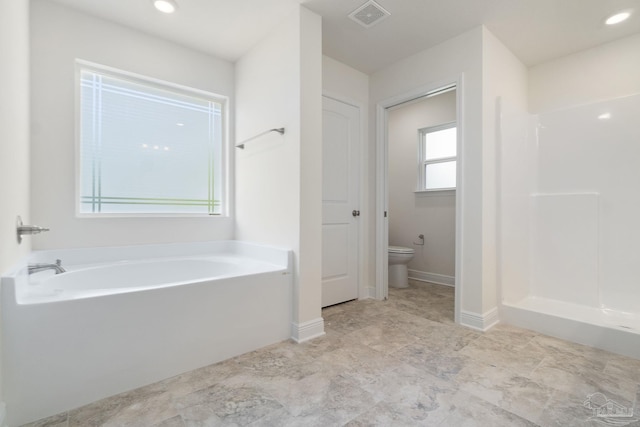 bathroom featuring plenty of natural light, toilet, and plus walk in shower