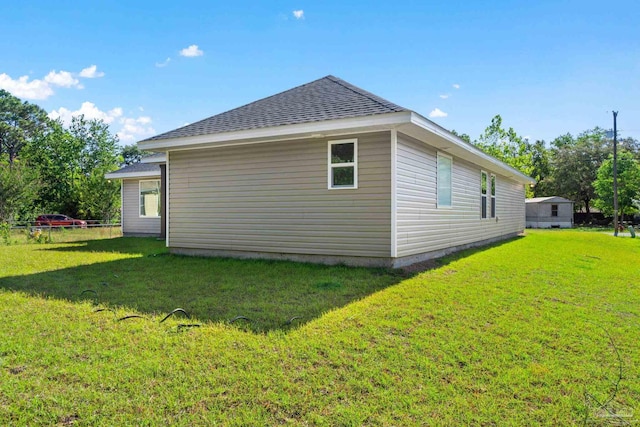 rear view of property featuring a yard