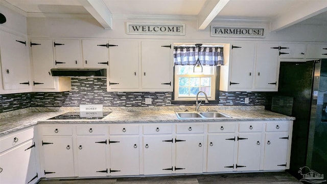 kitchen with beam ceiling, a sink, tasteful backsplash, range hood, and white cabinets