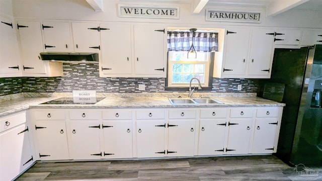 kitchen featuring dark wood-style flooring, a sink, decorative backsplash, extractor fan, and white cabinets