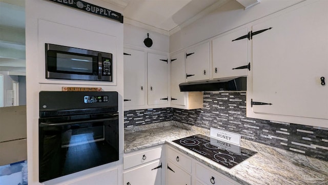 kitchen featuring black appliances, under cabinet range hood, white cabinets, crown molding, and decorative backsplash