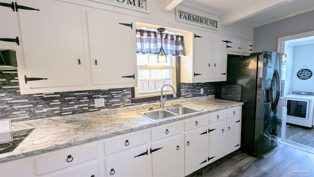 kitchen featuring decorative backsplash, white cabinets, light countertops, and a sink