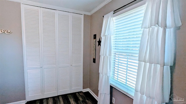 doorway to outside with crown molding, baseboards, and dark wood-style flooring