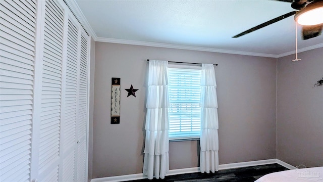 bedroom featuring a closet, baseboards, and crown molding