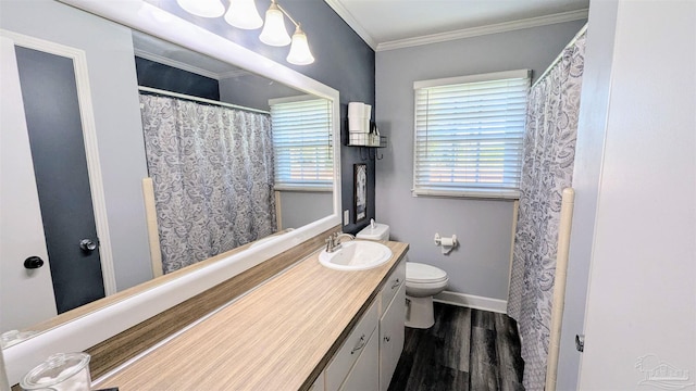 bathroom featuring toilet, wood finished floors, crown molding, baseboards, and vanity