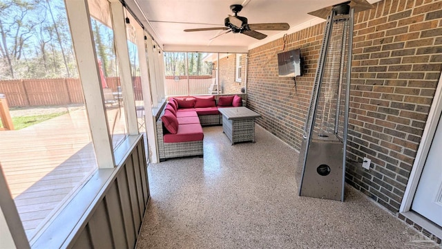 sunroom / solarium featuring a ceiling fan