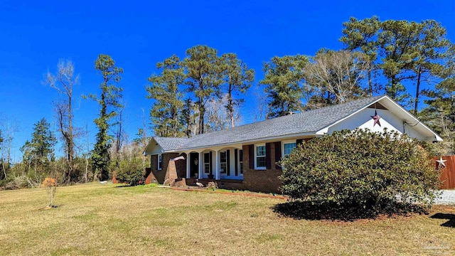 ranch-style home with a front lawn and brick siding