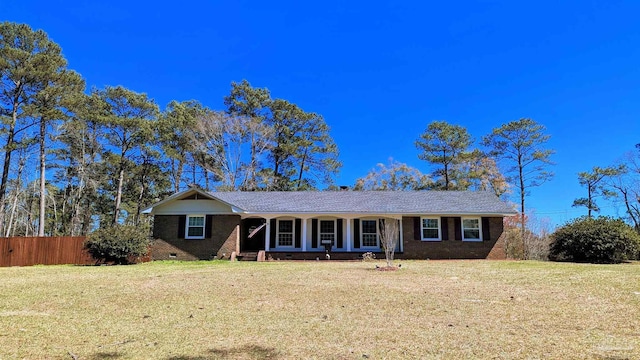 ranch-style home featuring crawl space, brick siding, a front lawn, and fence