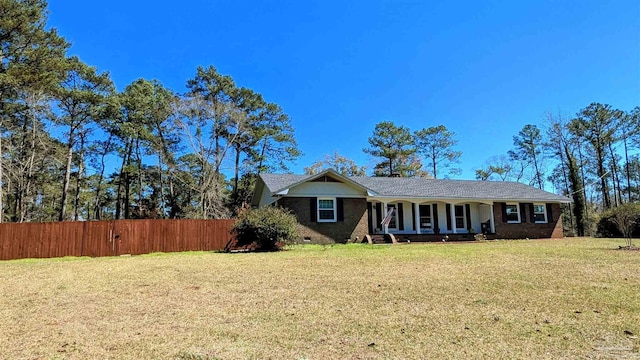 single story home featuring a front lawn, fence, brick siding, and crawl space