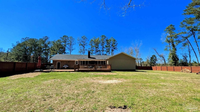 back of property featuring a fenced backyard, a yard, and a deck