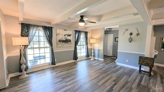 spare room with ceiling fan, beamed ceiling, baseboards, and wood finished floors