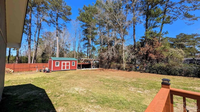 view of yard featuring an outbuilding, fence private yard, and a storage unit