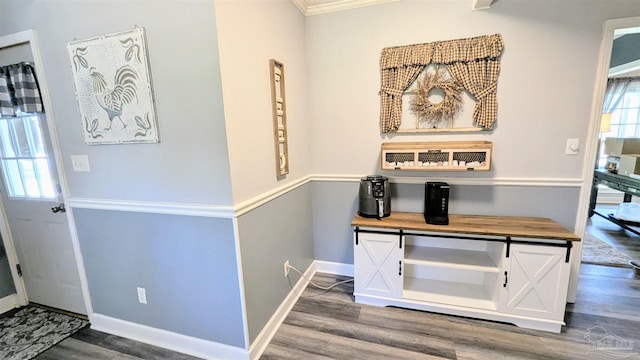 foyer entrance with wood finished floors and baseboards