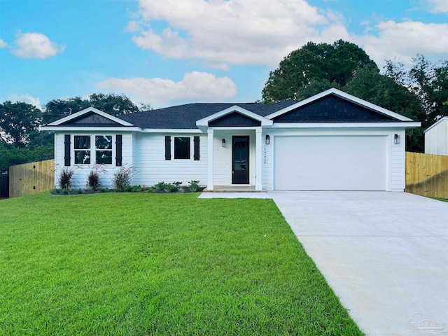 ranch-style home featuring driveway, an attached garage, a front yard, and fence