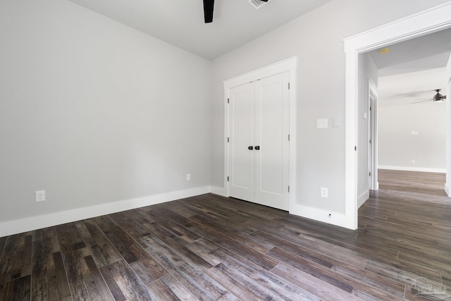 unfurnished bedroom featuring ceiling fan, a closet, and dark hardwood / wood-style flooring