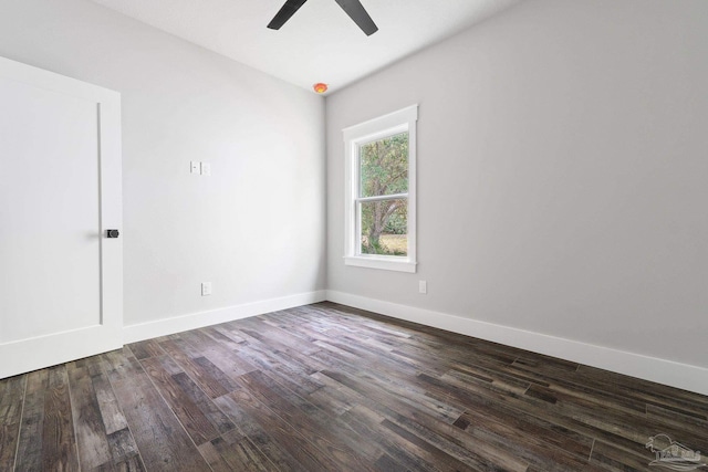 empty room with ceiling fan and dark hardwood / wood-style flooring