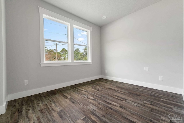 spare room with dark hardwood / wood-style floors