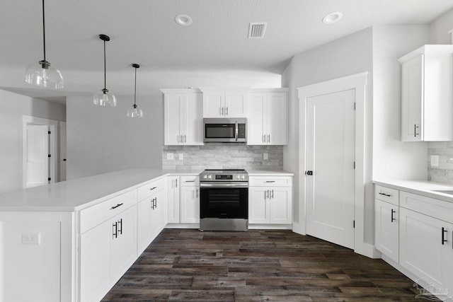 kitchen featuring kitchen peninsula, stainless steel appliances, decorative backsplash, decorative light fixtures, and white cabinets