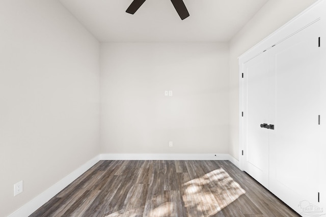 unfurnished room featuring dark wood-type flooring and ceiling fan