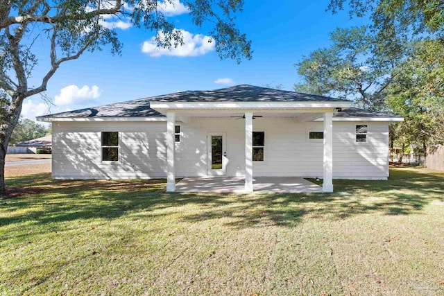 rear view of property featuring a lawn and a patio