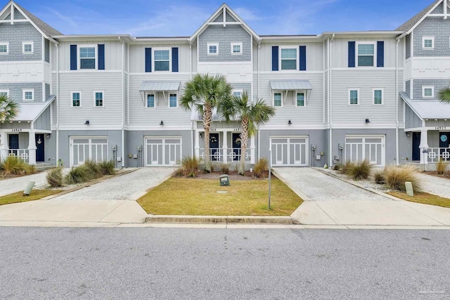 view of property featuring driveway, an attached garage, and a front yard