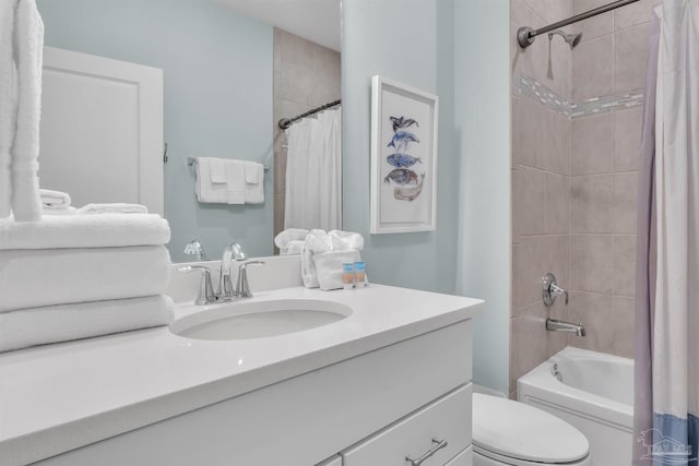 bathroom featuring shower / bath combination with curtain, vanity, and toilet