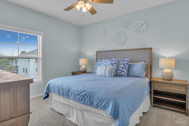 bedroom with a ceiling fan, carpet, and baseboards