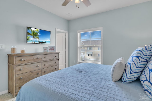 bedroom with ceiling fan and baseboards