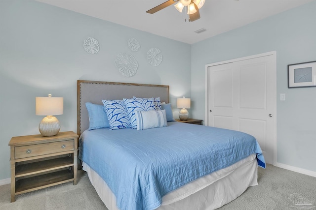 bedroom featuring a closet, visible vents, carpet flooring, ceiling fan, and baseboards