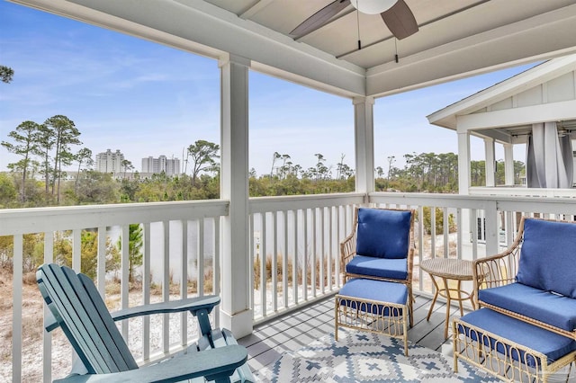 sunroom / solarium with a view of city and a ceiling fan