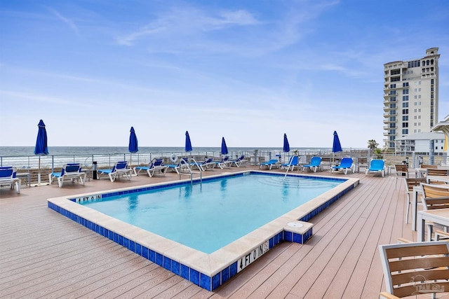 pool with a water view and fence