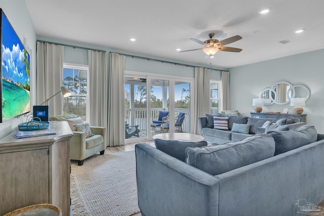 living room featuring ceiling fan, light wood-style flooring, visible vents, and recessed lighting