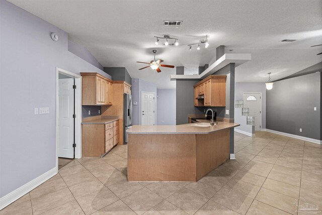 2759 Pleasant Bay Ct, Navarre, FL 32566 - kitchen with ceiling fan, a peninsula, light tile patterned flooring, a sink, and stainless steel fridge
