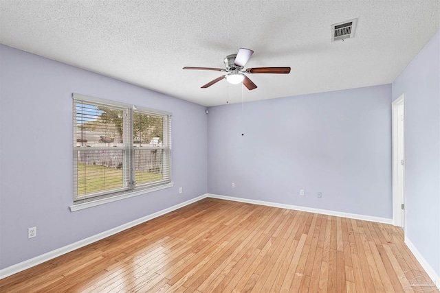 2759 Pleasant Bay Ct, Navarre, FL 32566 - empty room with a ceiling fan, light wood finished floors, a textured ceiling, and baseboards