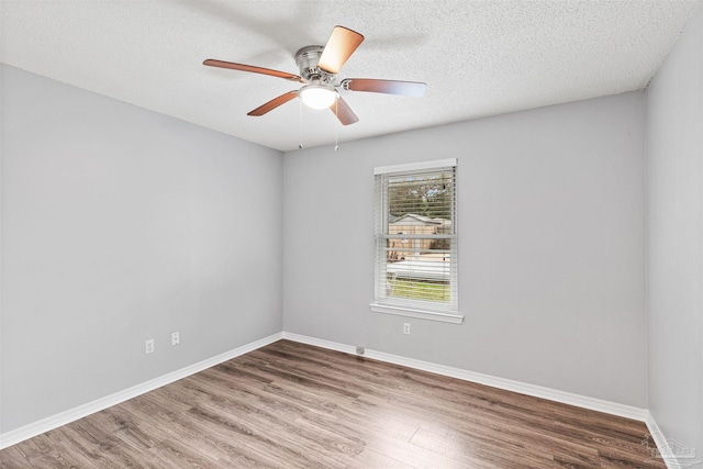 2759 Pleasant Bay Ct, Navarre, FL 32566 - spare room featuring wood finished floors, ceiling fan, baseboards, and a textured ceiling