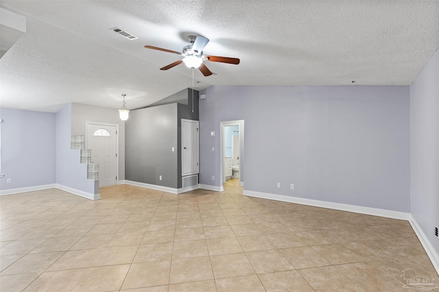 2759 Pleasant Bay Ct, Navarre, FL 32566 - empty room with a ceiling fan, vaulted ceiling, baseboards, a textured ceiling, and light tile patterned floors