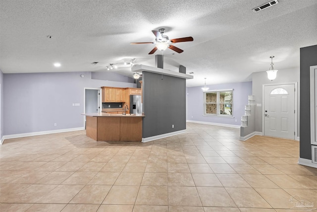 2759 Pleasant Bay Ct, Navarre, FL 32566 - kitchen featuring stainless steel fridge, open floor plan, vaulted ceiling, ceiling fan, and light countertops