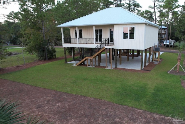 back of property featuring a patio and a yard