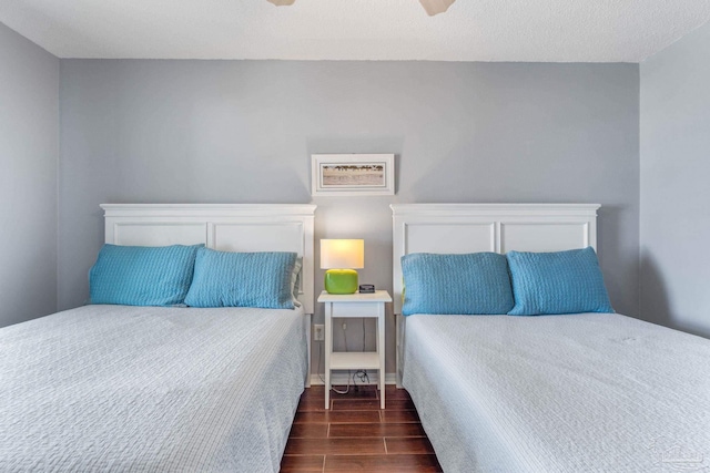 bedroom featuring dark hardwood / wood-style floors and ceiling fan