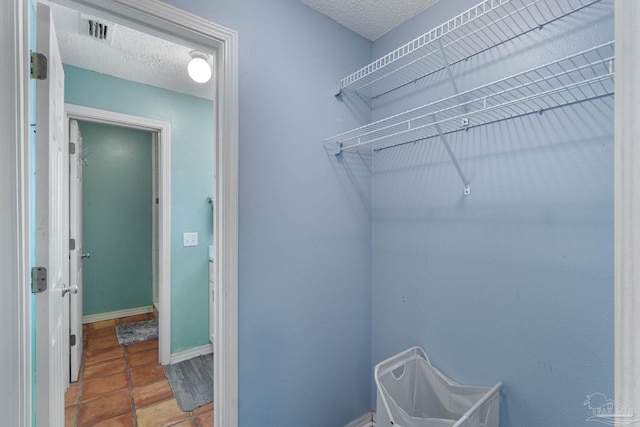 walk in closet featuring tile patterned flooring