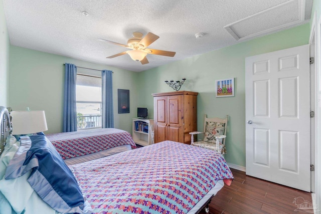 bedroom featuring ceiling fan, dark wood-type flooring, and a textured ceiling